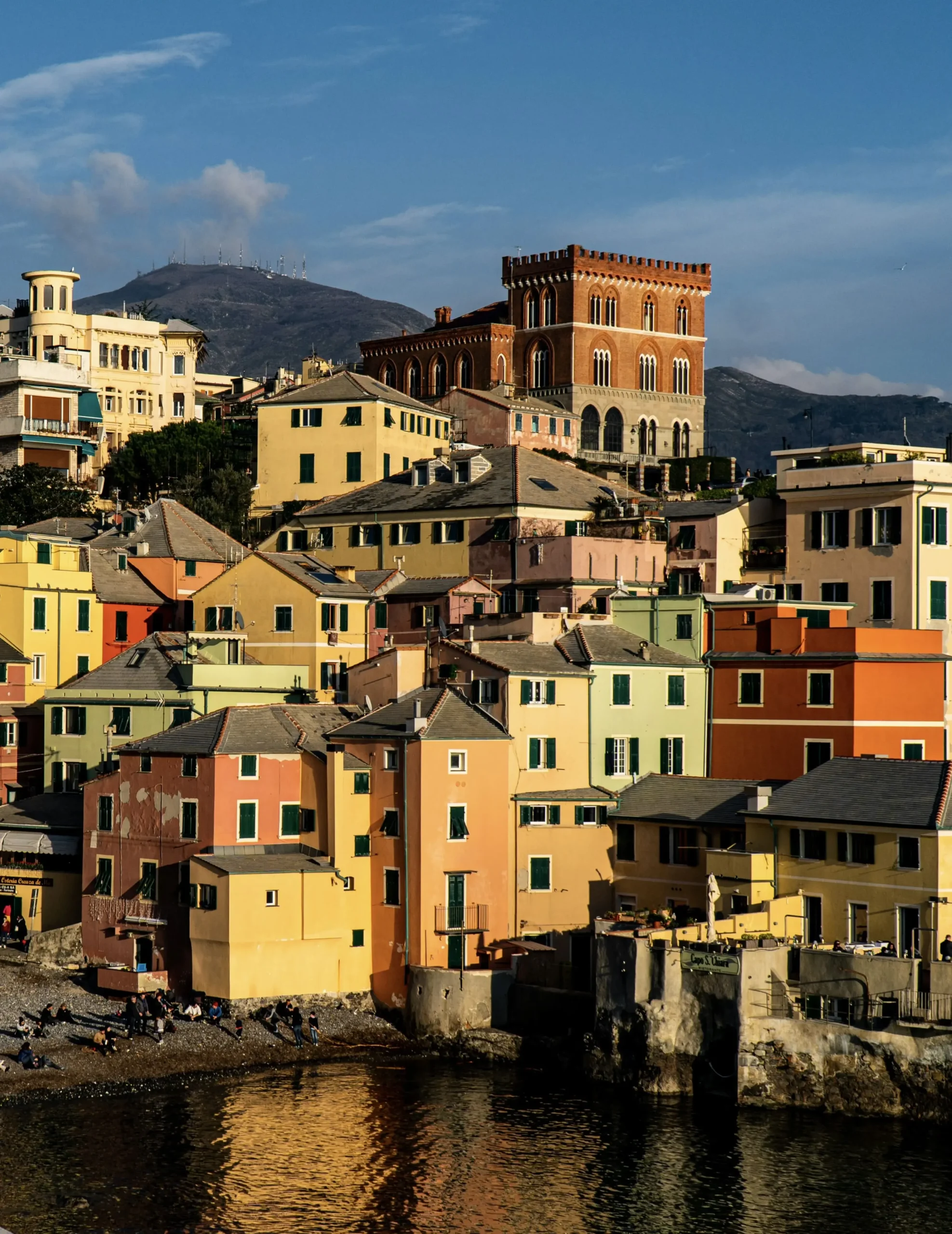 A picturesque view of Boccadesse, Genoa: colorful houses overlook the turquoise sea.